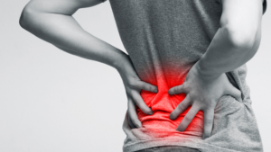 Patient lying on their back with pillow support under knees for sciatic nerve pain relief at night – Don Kelly Physiotherapy and Acupuncture